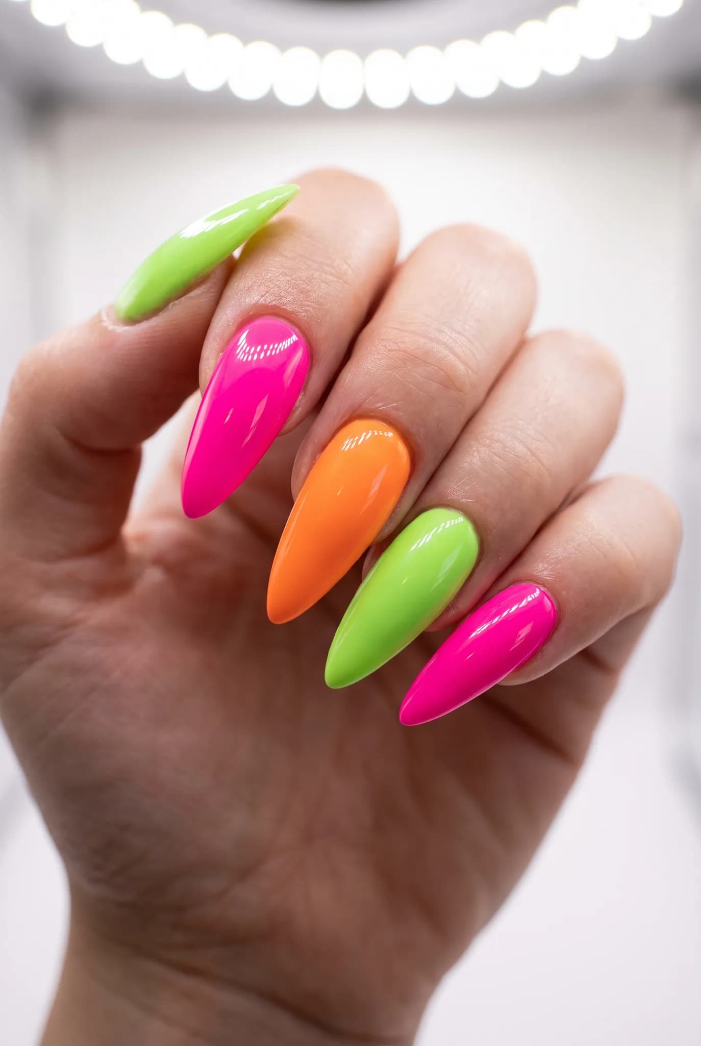 Close-up image of a professional studio showcasing various nail styles, including short, medium, long, and square with vivid designs.
